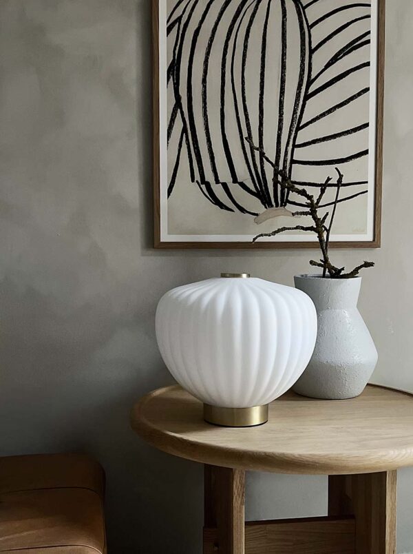 MOma bordlampe i hvidt opalglas med bølget kuppel og børstet messing base. Elegant design med blødt lys og luksuriøs messingfinish – perfekt til ethvert rum